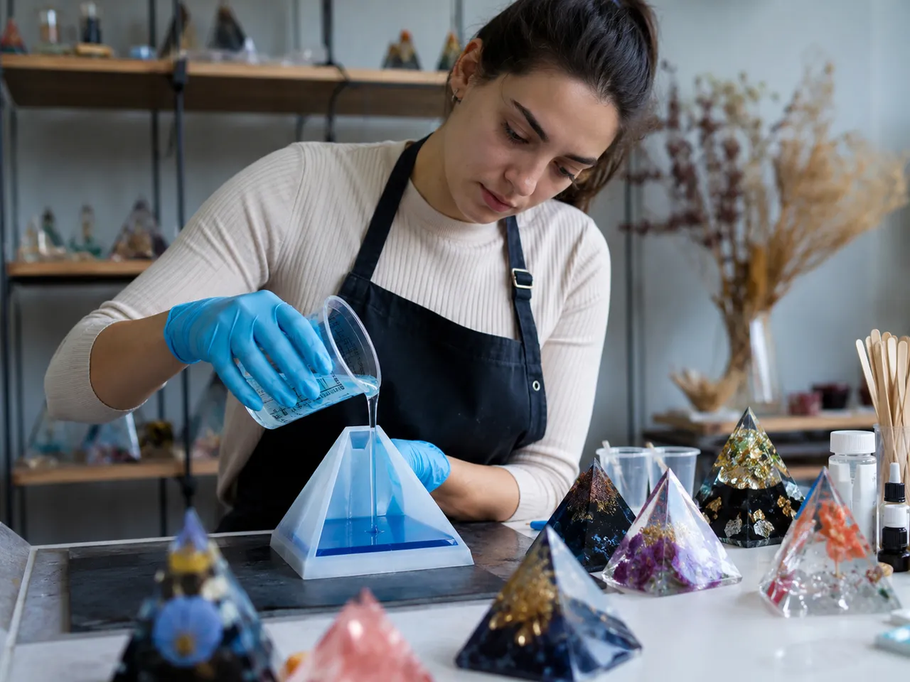 Resin pyramid craft on a maker's workbench.
